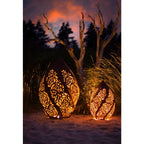 „Windlicht Rosentraum Edelrost in der Abenddämmerung, verleiht dem Garten eine romantische und einladende Atmosphäre“